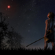 Artist’s depiction of a spear-wielding human gazing up at Scholz’s Star—a scene that probably never happened, given the red dwarf’s low luminosity.